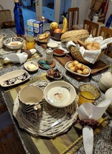 a table topped with plates and baskets of food at Casa Ecléctica in Santiago del Estero