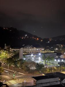 a city at night with buildings and street lights at Loft com Piscina no Rooftop centro de Blumenau in Blumenau