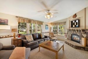 a living room with a couch and a fireplace at The Shady Grove Retreat in South Fork