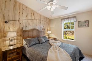 a bedroom with a bed and a ceiling fan at The Shady Grove Retreat in South Fork