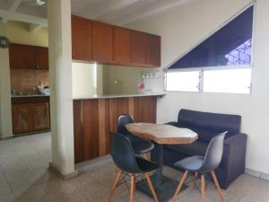 a kitchen with a table and chairs and a counter at Apart-hotel alessia in Santiago