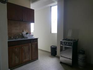 a kitchen with a sink and a stove in it at Apart-hotel alessia in Santiago