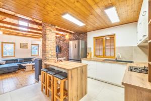 a kitchen with wooden ceilings and a living room at House Majda in Zagreb +15 photos