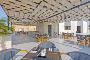 a restaurant with tables and chairs on a patio at Seven Stays New Cairo in Cairo