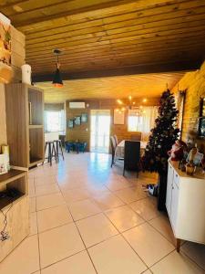 a kitchen and living room with a christmas tree in it at Casa com piscina a 300m praia in Imbituba