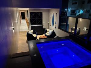 a room with a swimming pool in the middle of a room at V-Home Flat Hotel in Macaé