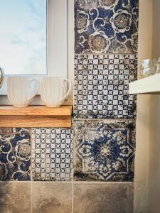 a bathroom with blue and white tiles on the wall at Maus Haus in Vrdnik +54 photos