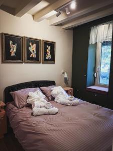 a bedroom with a bed with towels on it at Maus Haus in Vrdnik