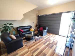 una sala de estar con dos sillas y una puerta de garaje corrediza en Prisma21, en Luque