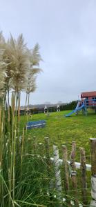 a park with a playground with a slide in a field at Apartament KOJA in Rewal