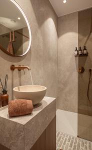 a bathroom with a sink and a tub and a mirror at Luxe Guestroom free bikes and parking in Bruges +19 photos