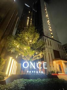 a once sign in front of a building at night at Once Pattaya Top Luxury Condo in the City Center in Pattaya Central