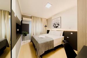 Ένα ή περισσότερα κρεβάτια σε δωμάτιο στο Aconchego, privacidade no centro, Joinville +22 φωτογραφίες