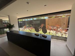 a room with a counter with a large window at 105 Dutra Ocean Flat - Take Home in Tambaú