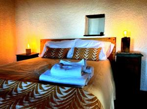 a bedroom with a bed with blue towels on it at Casas do Caminho in Lousã