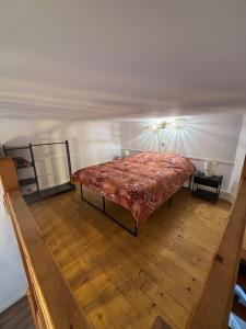 a bedroom with a bed in the corner of a room at le cocon valenciennes gare in Valenciennes