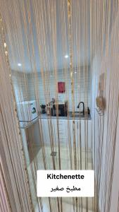 a glass window with a sign that reads kittichenerate at مخيم وشاليه ياسمين حتا Jasmin Hatta Camp & Chalet in Hatta