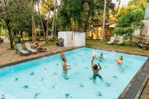 eine Gruppe von Menschen, die in einem Schwimmbecken spielen in der Unterkunft Lime Ahangama in Ahangama
