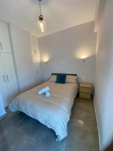 a bedroom with a bed with a blue folder on it at Casa del Rey in Piraeus