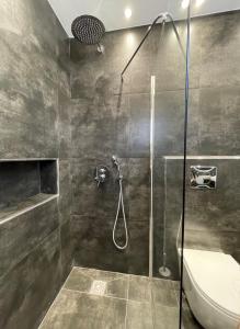 a bathroom with a shower and a toilet at Casa del Rey in Piraeus +5 photos