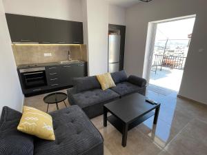 a living room with a couch and a table at Casa del Rey in Piraeus