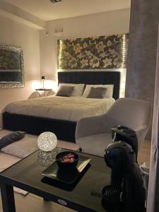 a bedroom with a large bed and a table with a coffee table at Artemide Resort Spa - Private Villa & Spa Suites in Lido Di Fondi