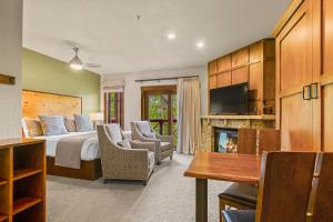 a hotel room with a bed and a fireplace at Hyatt Main Street Station Studio in Breckenridge