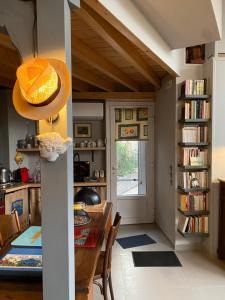 a dining room with a table and a book shelf at eliamaria domus artificis in Lefkada Town