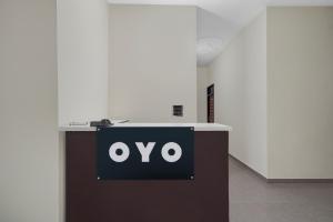 a black and white sign on a table in a room at Hotel O Choudhary Hotel and Resort in Anūpnagar +21 photos