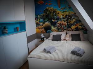 une chambre avec un lit avec une fresque de poisson sur le mur dans l'établissement Apartmány Hradební 16, à České Budějovice