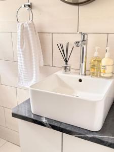 a bathroom with a white sink and a mirror at Home@Amalia’s in Rundu +43 photos