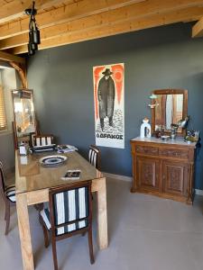 a dining room with a wooden table and a mirror at eliamaria domus artificis in Lefkada Town