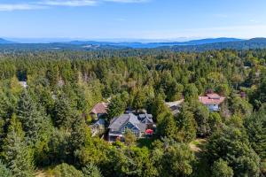 an aerial view of a large house in the forest at Shawnigan Suite B & B in Shawnigan Lake