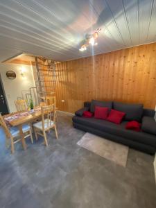 a living room with a couch and a table at Ferienwohnung Bergheimat in Wenns
