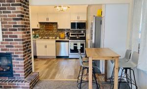 a kitchen with a table and a brick wall at Lake Trail Cottage in Michigan City