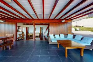 a living room with a couch and a table at Villa Mangouste in Terre-de-Haut