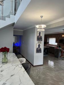 a living room with a table and a staircase at ALIMU villa Mbombela in Nelspruit +47 photos
