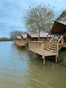 a row of wooden docks in the water at Cozy Glamping Minutes from SpaceX Launches in Colonia Acres
