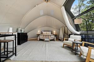 an attic bedroom with a bed in a room at Escape to Cloud Nine Glamping in the Black Hills in Keystone