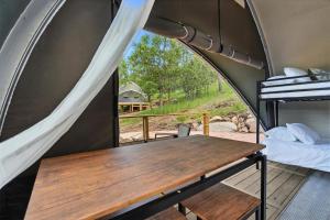 a table in a tent with a view of a field at Glamping in Nature Near Mt Rushmore in Keystone
