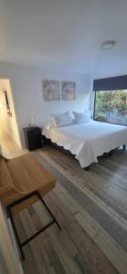 a bedroom with a large bed and a window at Casa mediterránea Villamar Guanaqueros in Guanaqueros