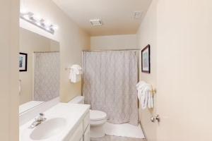 a white bathroom with a toilet and a sink at Eagle's Nest in Big Creek +11 photos