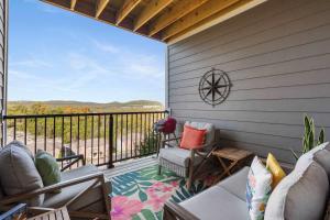 a screened in porch with a view of the mountains at Crossroads Vistas - 3BDR Condo in Branson