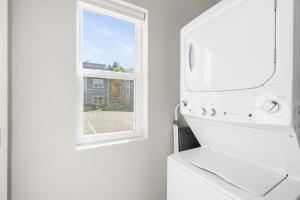 a kitchen with a white stove and a window at Crossroads Vistas - 3BDR Condo in Branson +17 photos