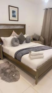 a bedroom with a large bed with pillows at Waves luxury in Accra