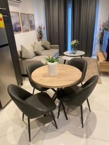 a dining table and chairs in a living room at Waves luxury in Accra