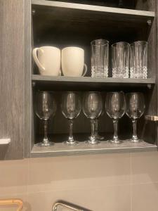 a row of wine glasses sitting on a shelf at Waves luxury in Accra +6 photos