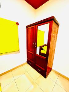 a room with a wooden door with a mirror at Kalpho Art Center in Kigali
