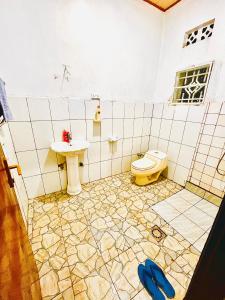 a bathroom with a sink and a toilet at Kalpho Art Center in Kigali