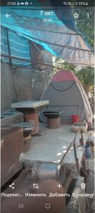 a tent with a table and a picnic table at Mrganush kamp in Meghri